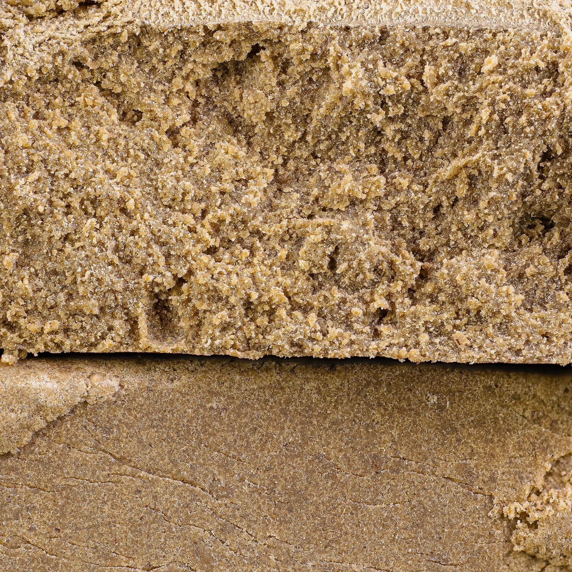 Close-up of a thca dry sift hash with visible texture