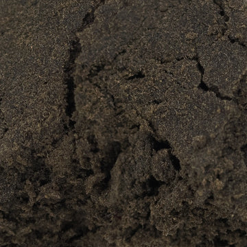 Close-up of dark brown cbd hash texture